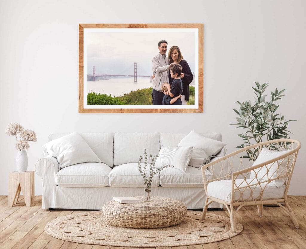 Family portrait framed above living room couch.