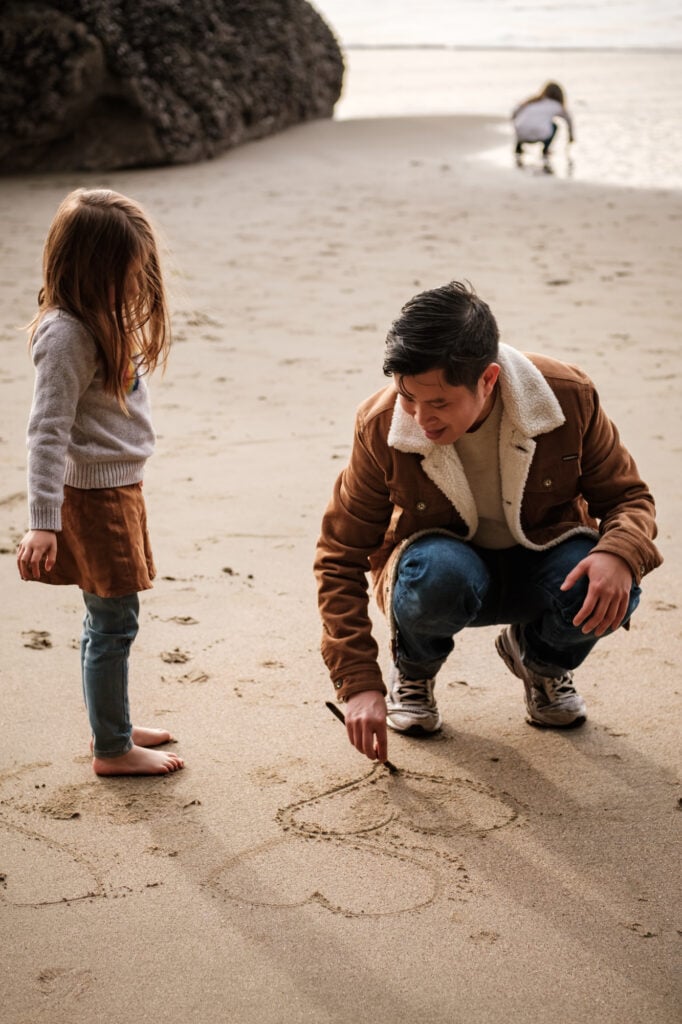Dad draws heart in the sand for his daughter
